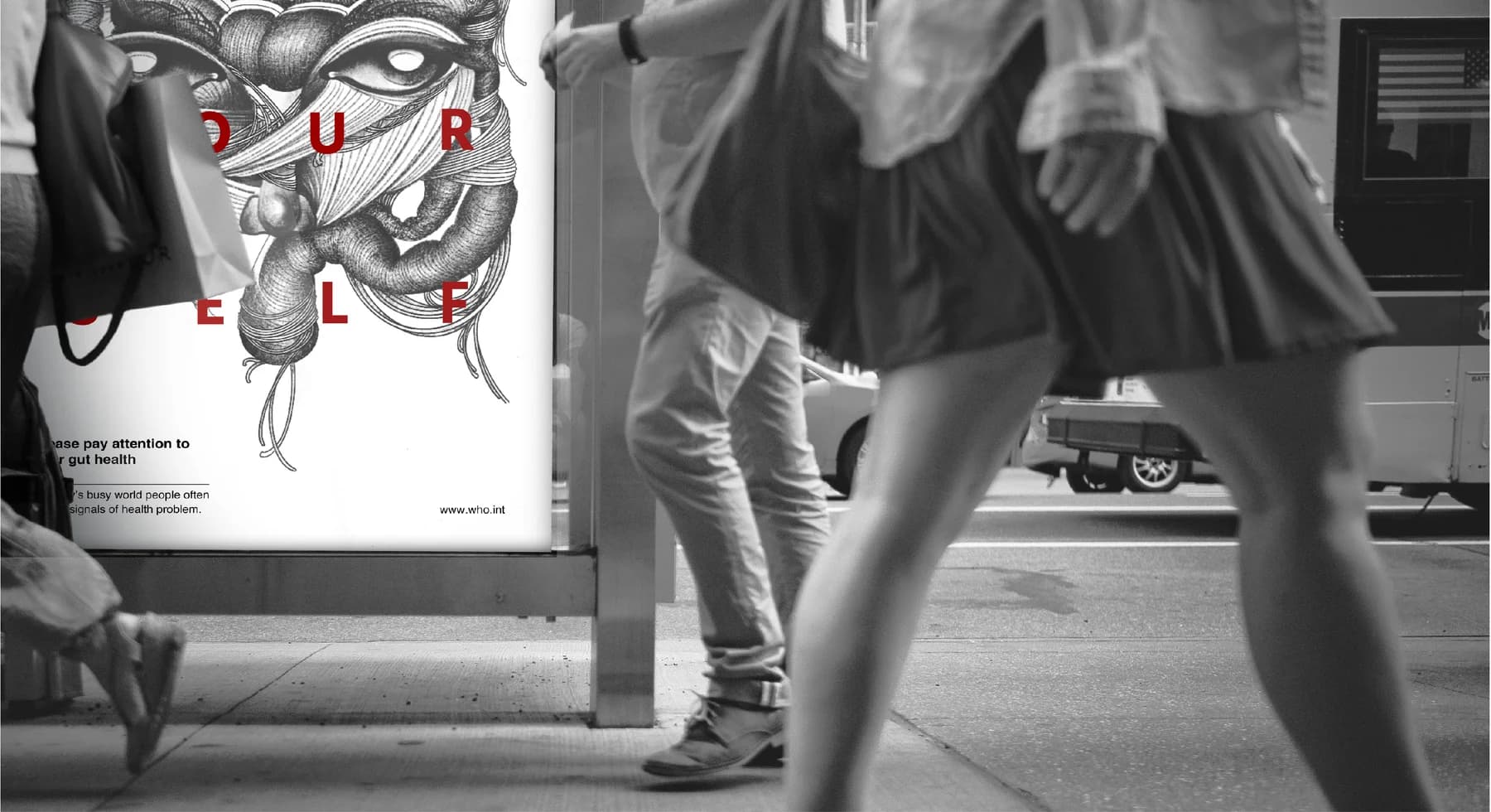 Self-Healthcare campaign poster at a bus shelter with pedestrians passing by